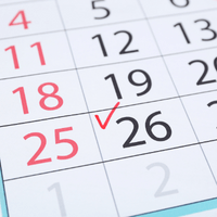 Check mark in calendar on date of 26th, close up By Africa Studio 